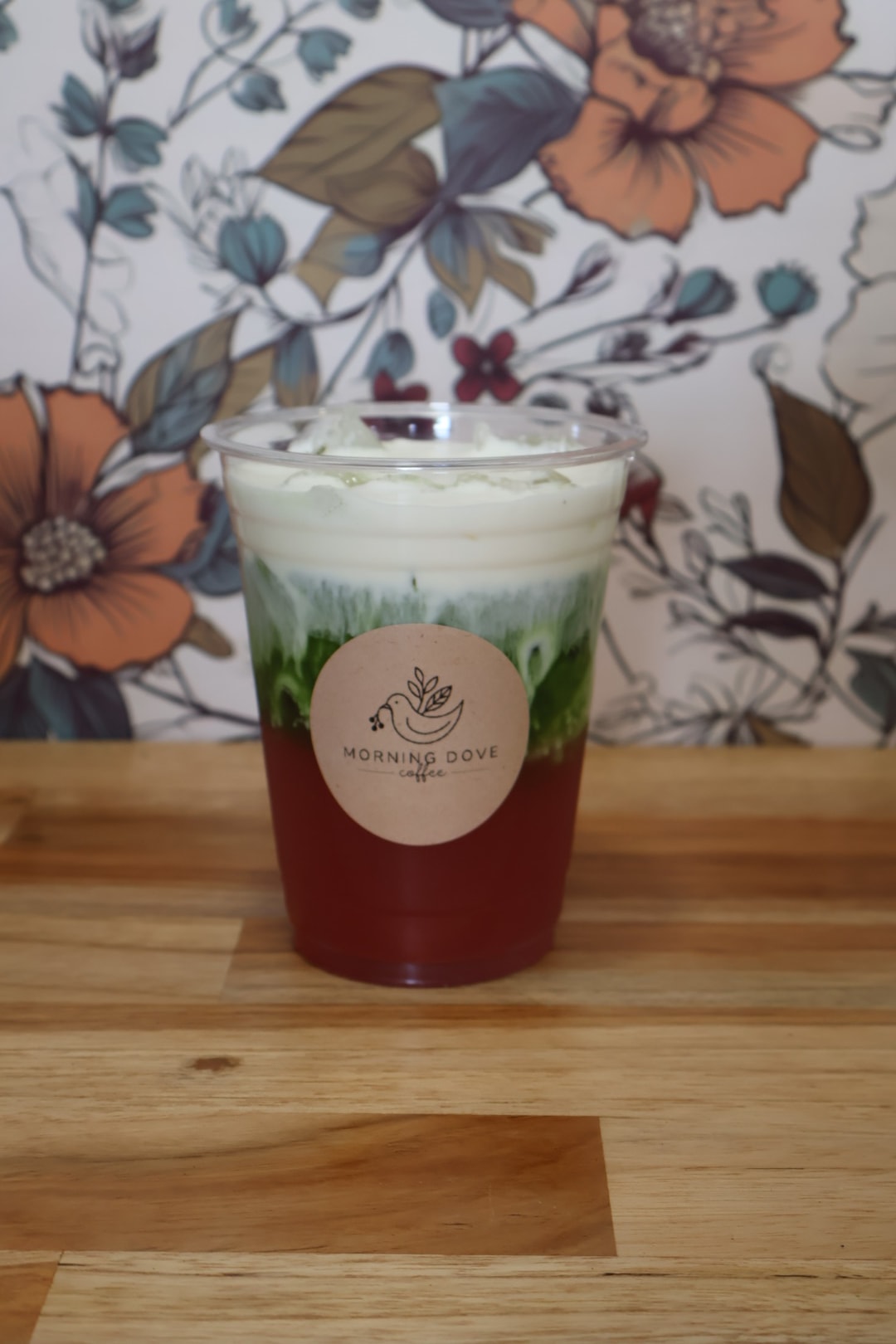 Four branded Morning Dove iced drinks arranged on a wooden surface