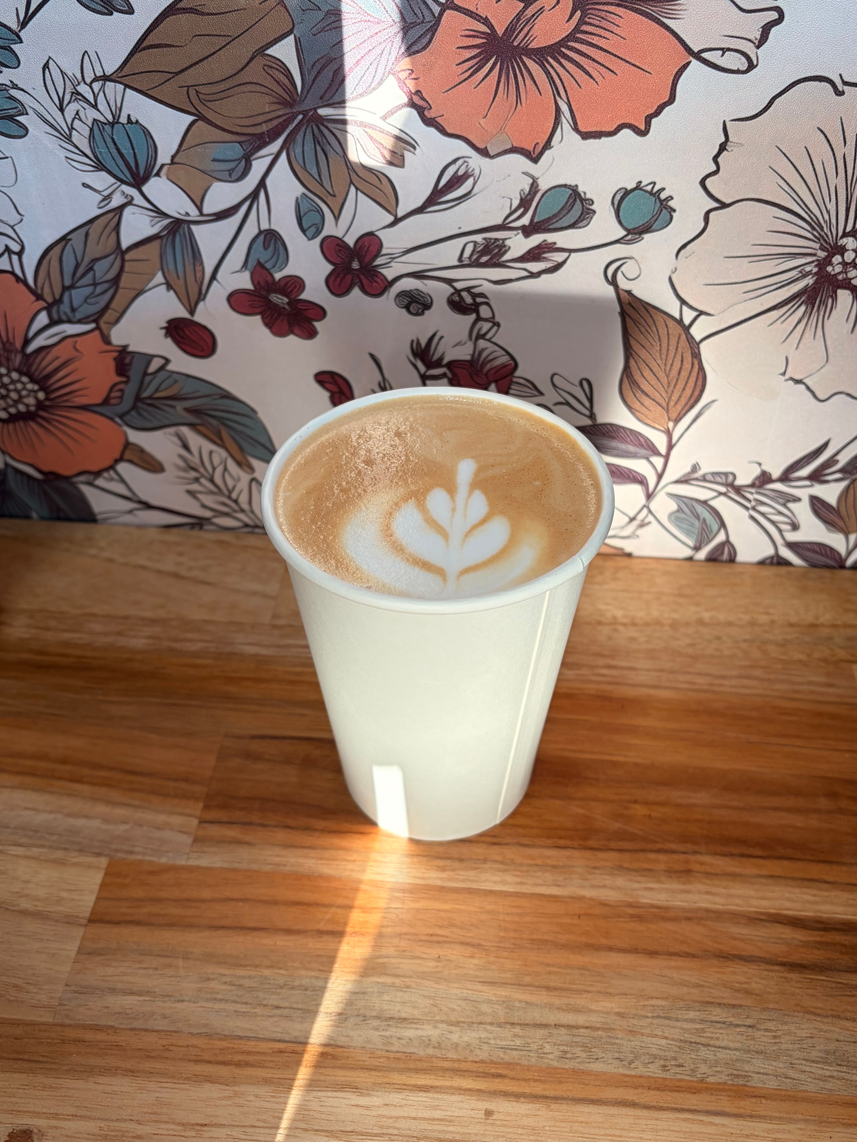 Three specialty Morning Dove Coffee beverages on a wooden surface